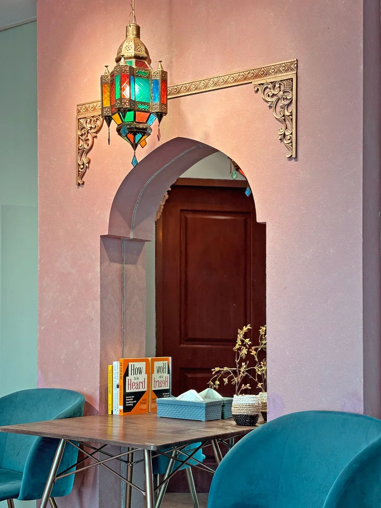 Marrakech: A Moroccan arch with a coloured-glass lantern, the two-person dining table below.