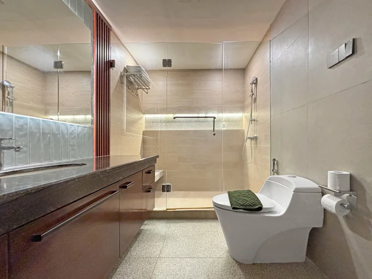 Okinawa: A bathroom with a separate shower and toilet, one of three in the unit.