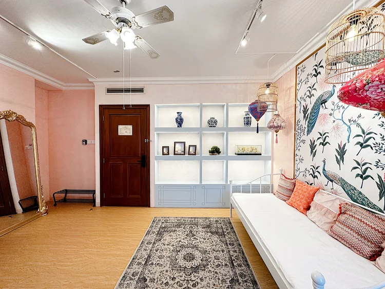 Malacca: A tall mirror and display shelves by the entrance, Peranakan down to the details.