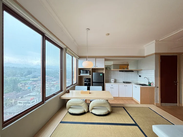 Fukuoka: Low tatami-style dining table by the wide windows, with floor cushions.