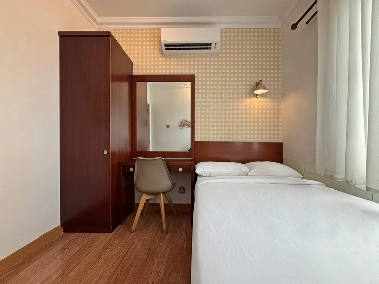 Busan: Another bedroom with a dressing table and its own AC, sheer curtains at the window.