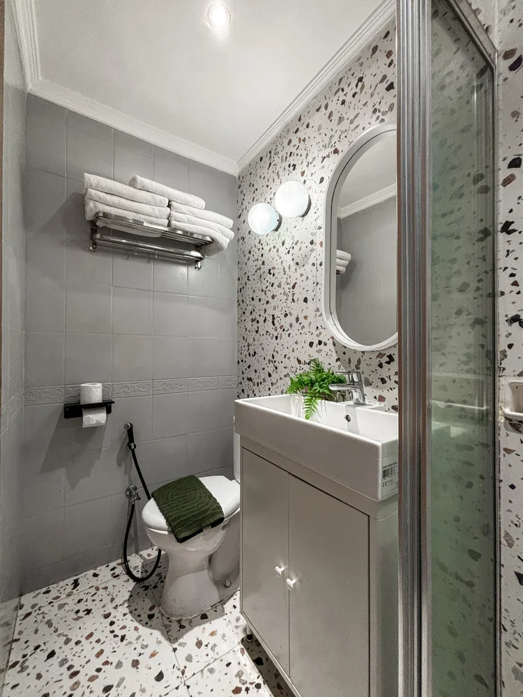 Geneva: Bathroom with terrazzo flooring and its own sink.