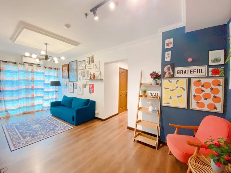Palermo: Sleeps 8, up to 12 with extra beds: Palermo's living room with a gallery wall and blue sofa.