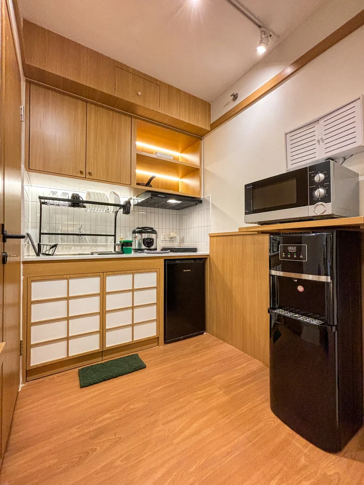 Omotesando: Open kitchen with microwave, fridge and shoji panels under the cabinets.