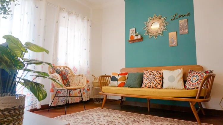 Havana: Havana Eclectic: a rattan chair and sunburst mirror on the teal wall, sleeps 6, up to 10 with extra beds.