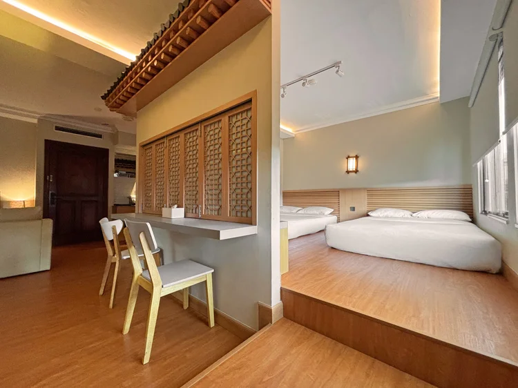 Nami: The sleeping area behind the lattice: two small double beds with AC.