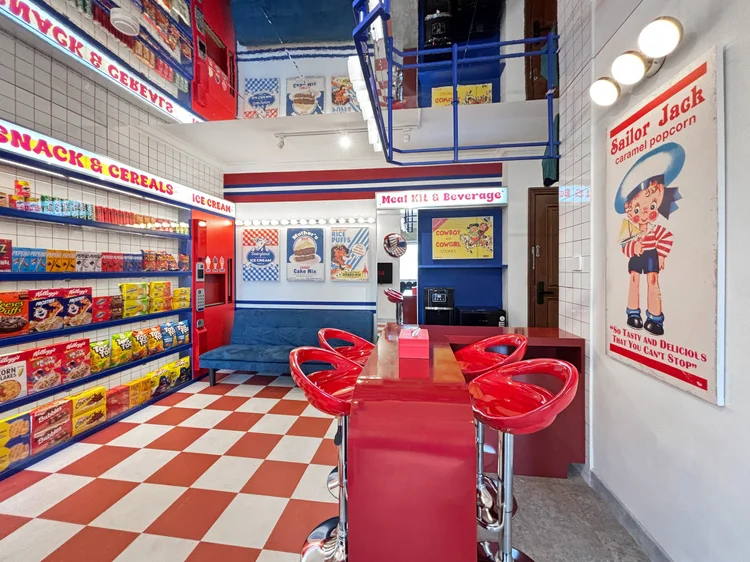 Miami: A red bar table with stools, vintage posters on the wall.