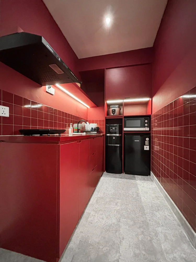 Helsinki: Red kitchen with a mini fridge and microwave; the lobby convenience store sells the basics for cooking.