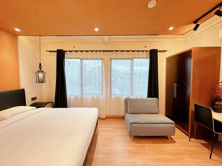 Melbourne: A wardrobe and wide window in the bedroom, with its own AC.