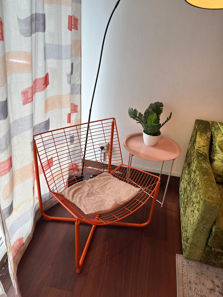 Namibia: Orange wire chair with a small table, a corner to relax beside the sofa.
