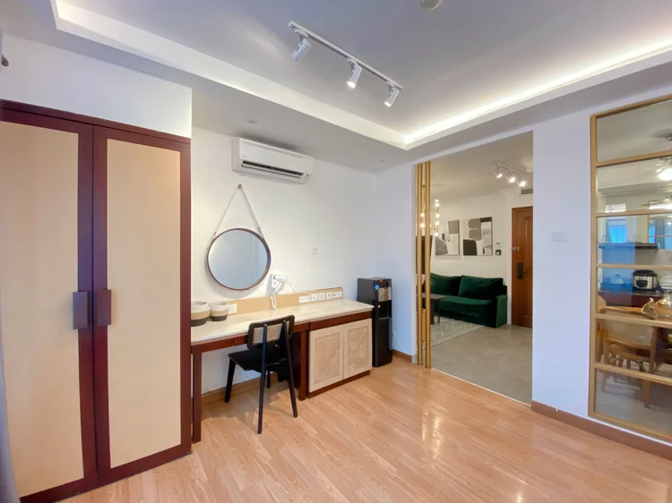 Budapest: Wardrobe, dressing table with a round mirror, and AC in the bed area.