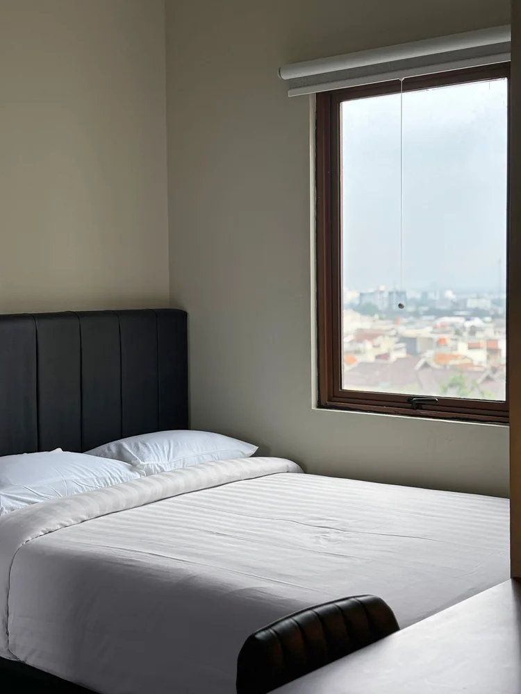 Saitama: A bedroom with a single bed and a window; AC in every bedroom.