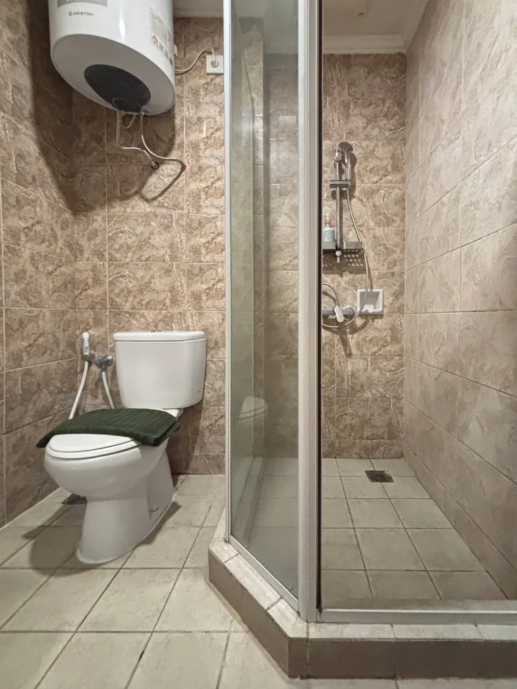 Namibia: Bathroom with a glass-doored shower and a water heater.