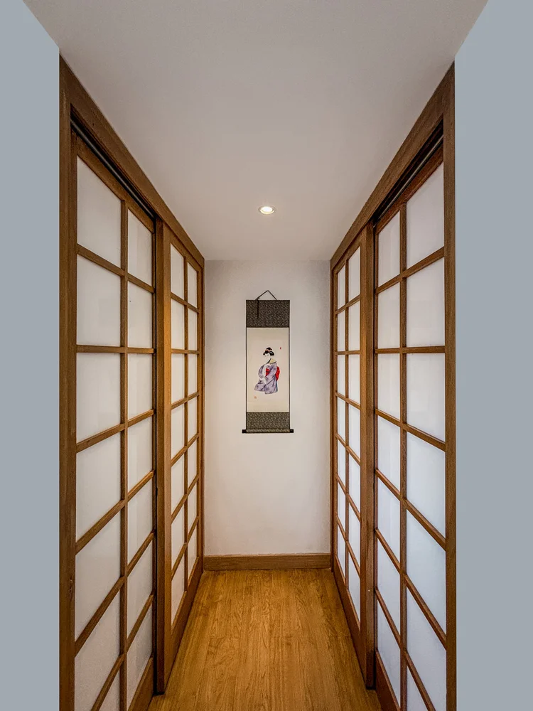 Yokohama: A hallway with sliding shoji doors and a Japanese scroll ornament on the wall.