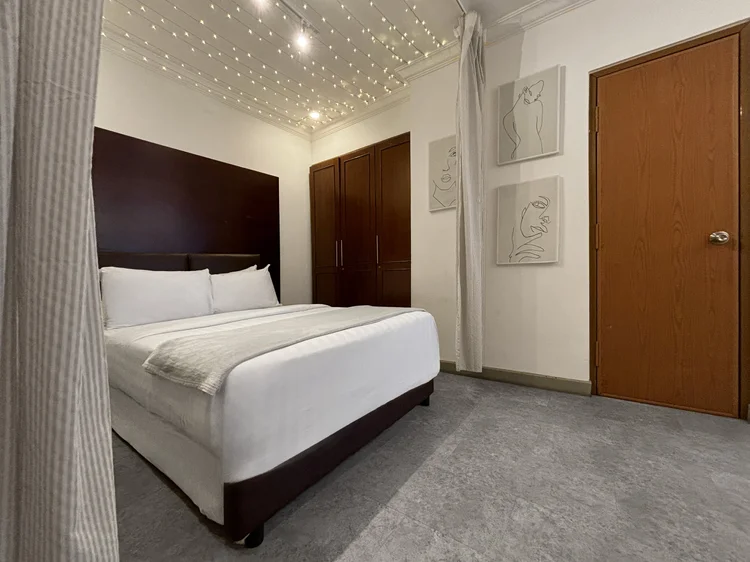 Ubud: Master bedroom with a dark wood wardrobe and a ceiling dotted with tiny star-like lights.