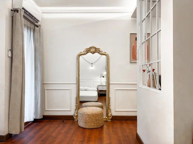 Provence: A tall gold-framed mirror for a last check before heading out.