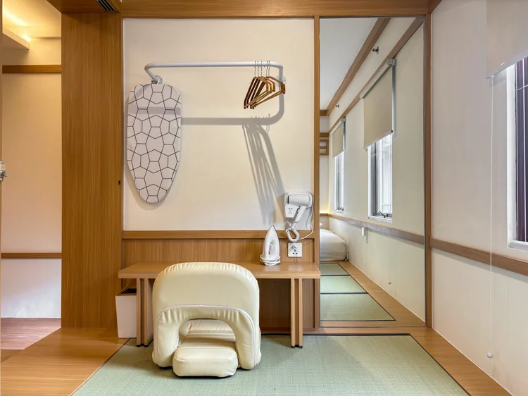 Omotesando: An open wardrobe and a floor table in the bedroom, minimal Japanese style.