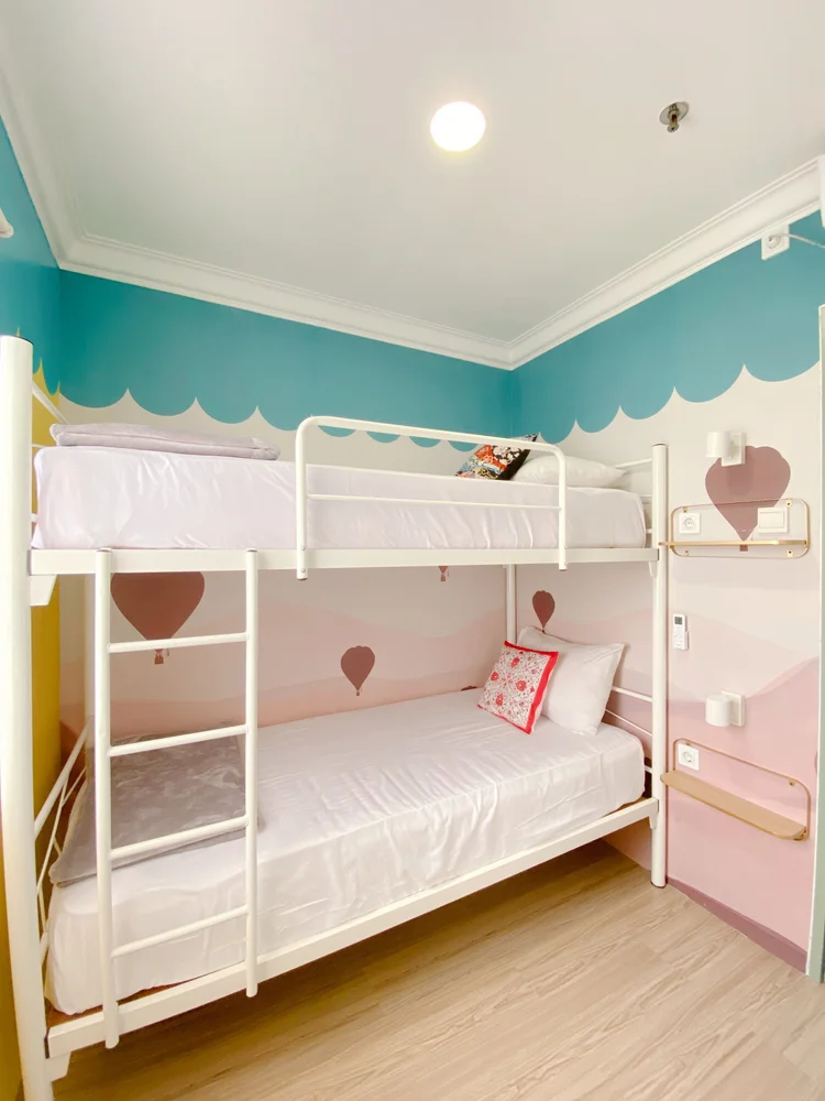 Cappadocia: A bedroom with a bunk bed for two and its own AC, with the balloon mural on the wall.