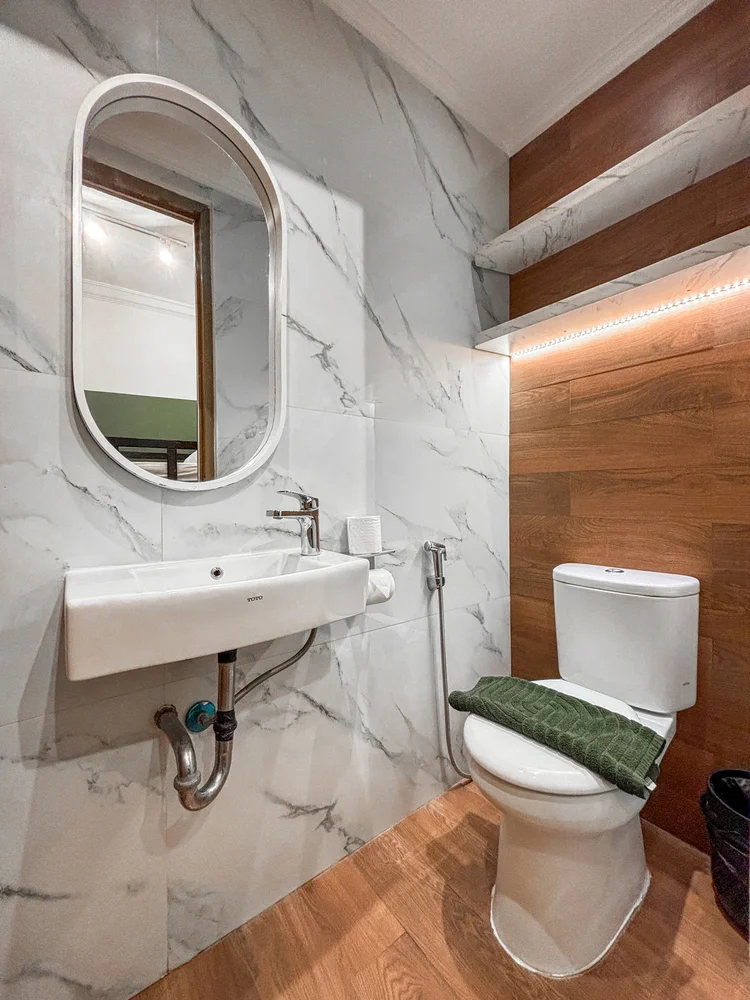 Salzburg: The small bathroom off the bunk-bed room: basin and toilet, with a wood floor.