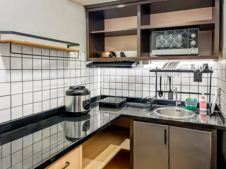 Yokohama: A semi-enclosed kitchen with white tiles, a sink and a rice cooker; the basic cooking tools are all there.