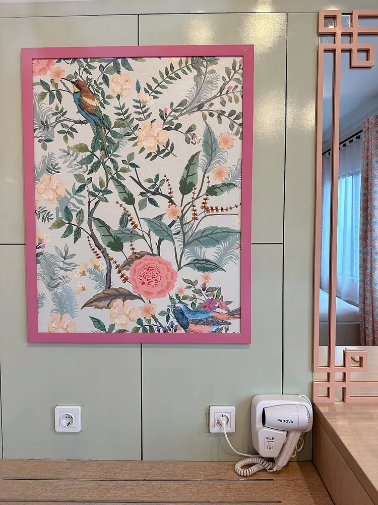 Malacca: A wardrobe with a floral painting, where clothes come out of the suitcase.