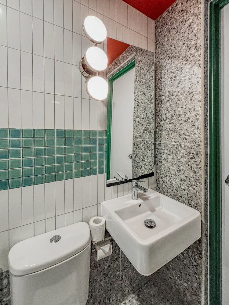 Hong Dae: Bathroom with basin and mirror; the soap and shampoo are the same in every unit.