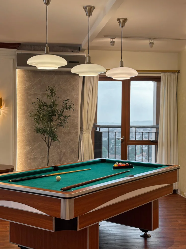 Kensington: A large balcony with a patio table and mountain view, right off the billiard room.