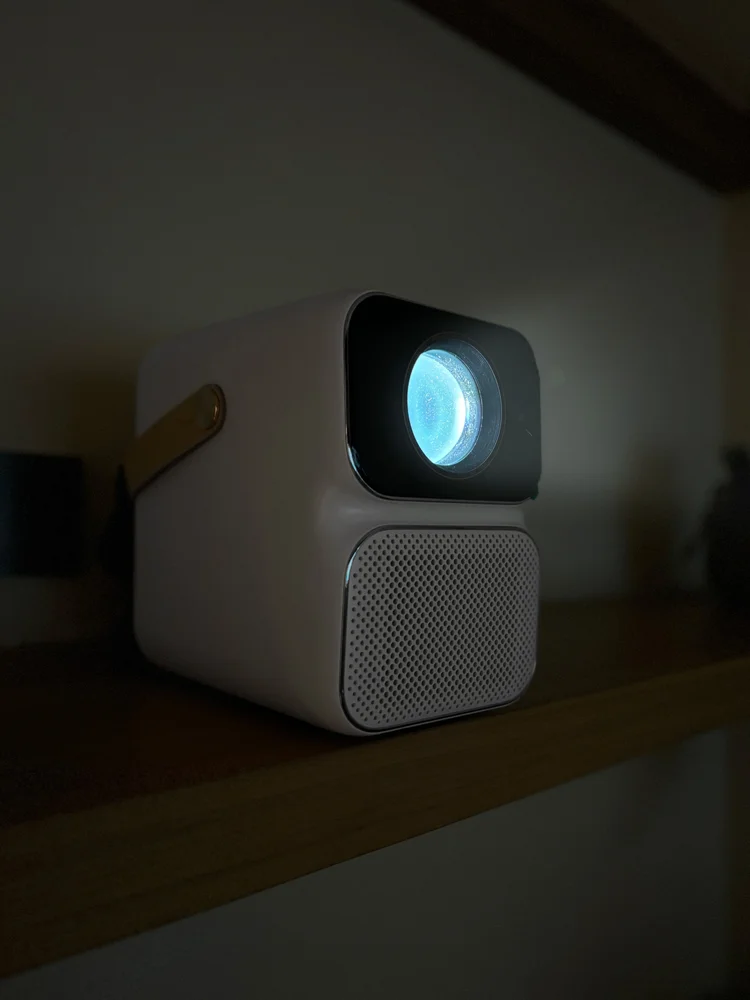 Kawaguchi: A smart projector for movie nights, with a home cinema screen across from the sofa.