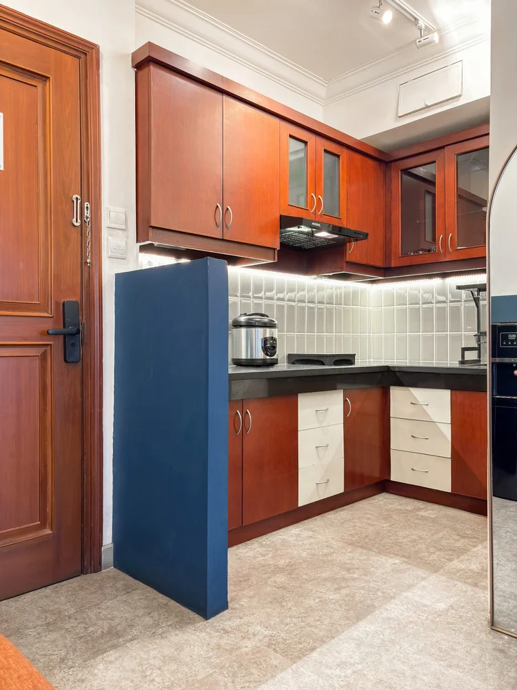 Chicago: The open kitchen just past the front hallway, with wood cabinets and white tile.