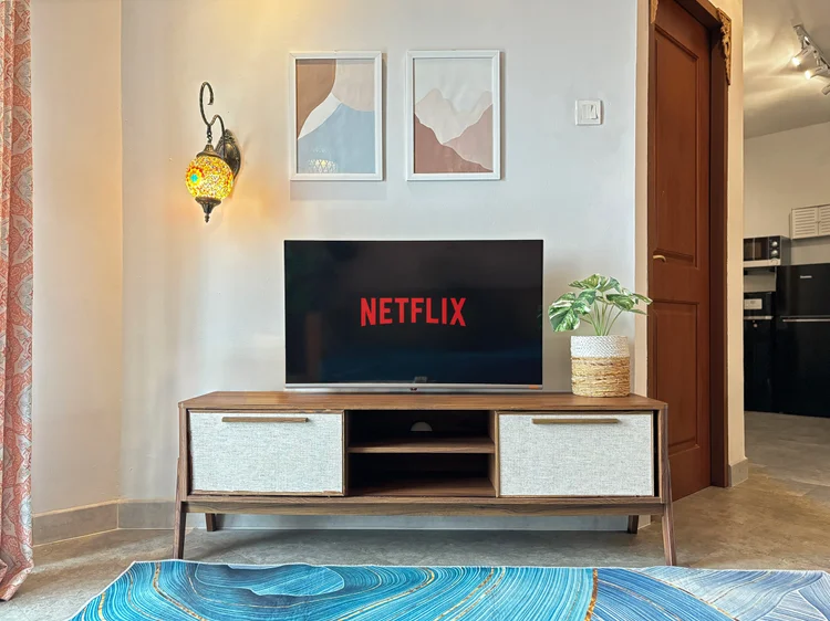 Marrakech: Smart TV with Netflix on the credenza, under prints and a Moroccan lamp.