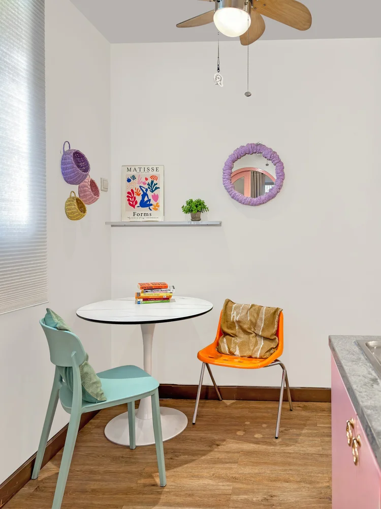 Milan: A dining table for two under the ceiling fan.