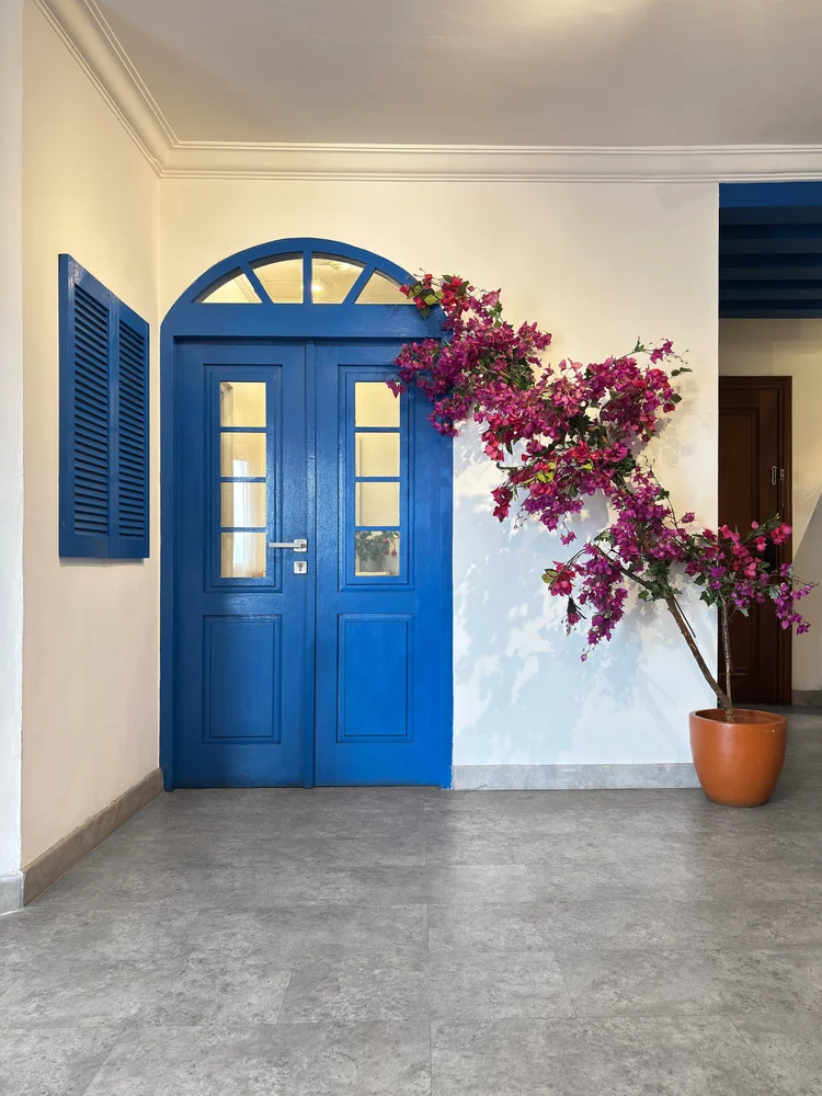 Santorini: Blue door and bougainvillea at the entrance, true to the Island Dream theme.