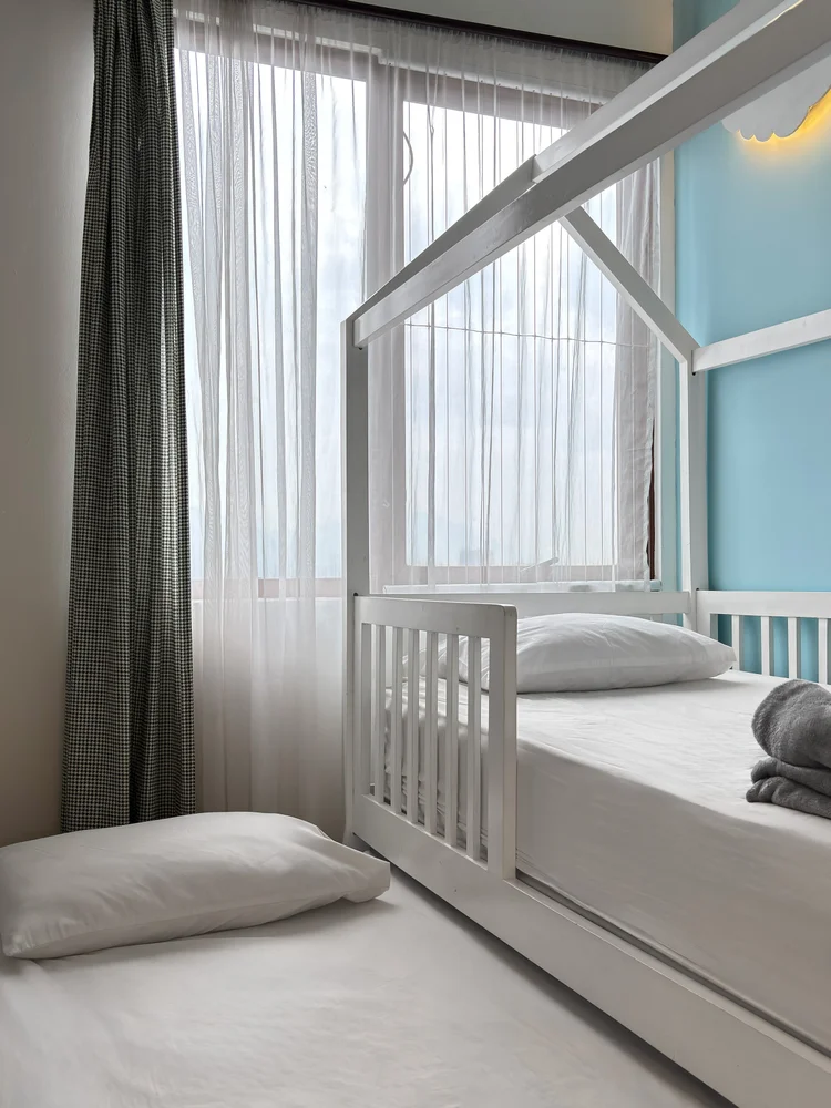Mykonos: A bedroom with a house-frame sliding single bed and its own AC.