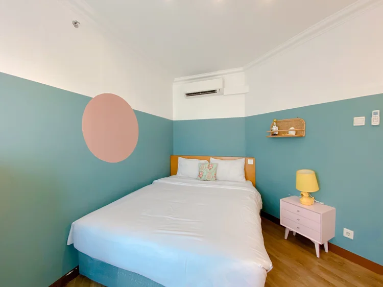 Madison: Another bedroom in blue, with AC and a bed for two.