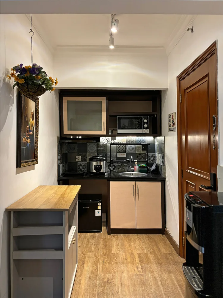 Florence: Open kitchen with a microwave and wood cabinets; the lobby convenience store sells the basics for cooking.