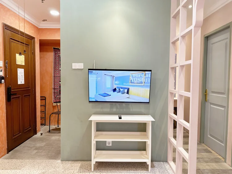 Cappadocia: The front door opens into the living room, with the TV and white wooden screens.