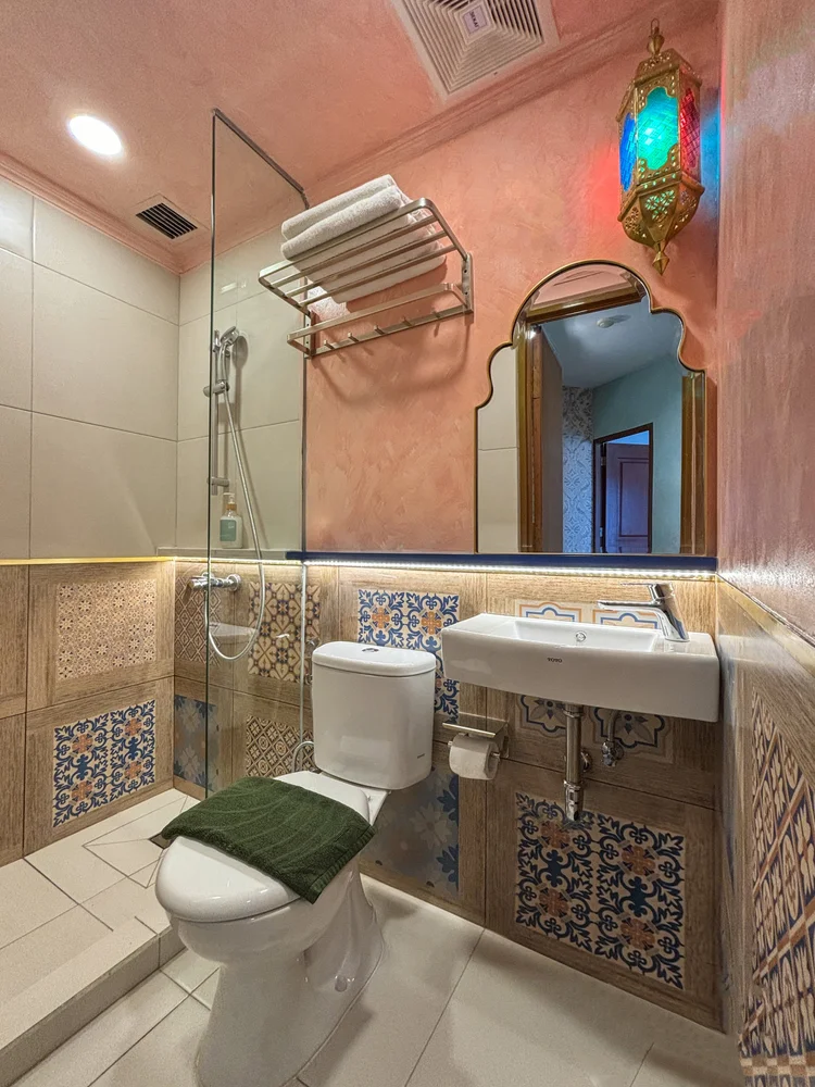 Marrakech: Bathroom with a hot-water shower behind glass and Moroccan tiles.