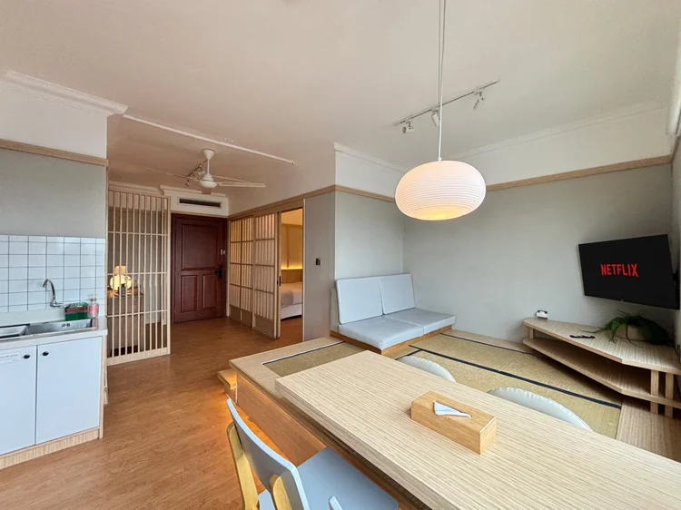 Fukuoka: Two-seater floor sofa facing the smart TV with Netflix, ceiling fan above.