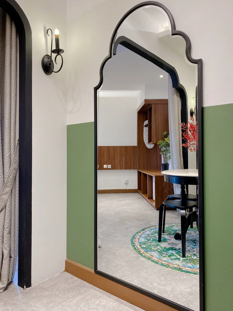 Saigon: A tall arched mirror for a last check before heading out.