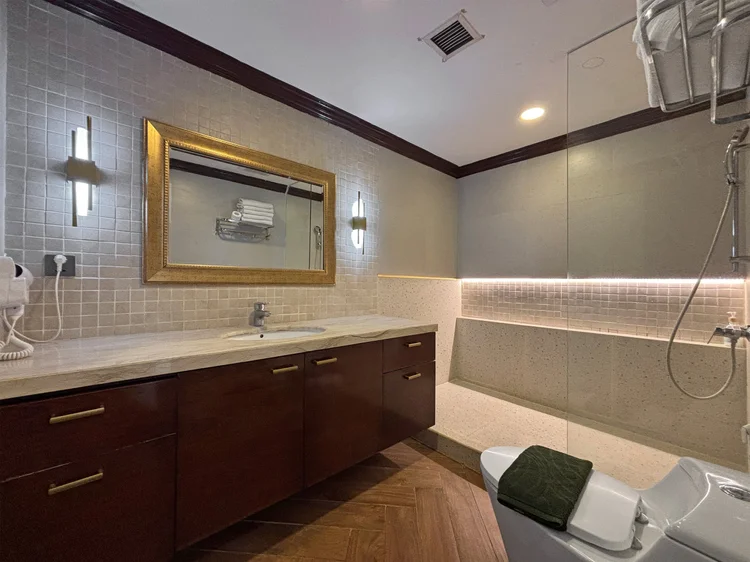 Kensington: Another bathroom with a long vanity and a shower, one of three in the unit.