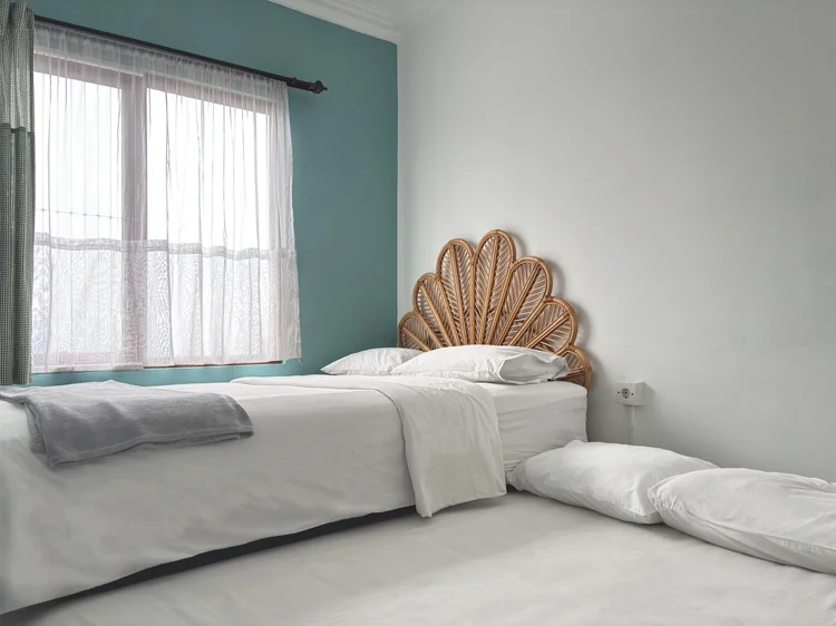 Mykonos: A bedroom with a 140 + 140 cm sliding small double bed and a rattan shell headboard.