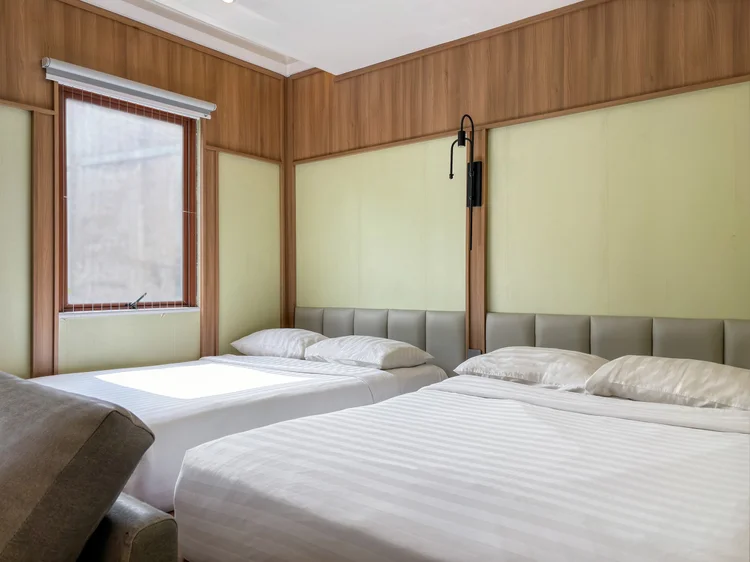 Sapporo: Two Japanese-style small double beds side by side on the platform, with AC in the bed area.