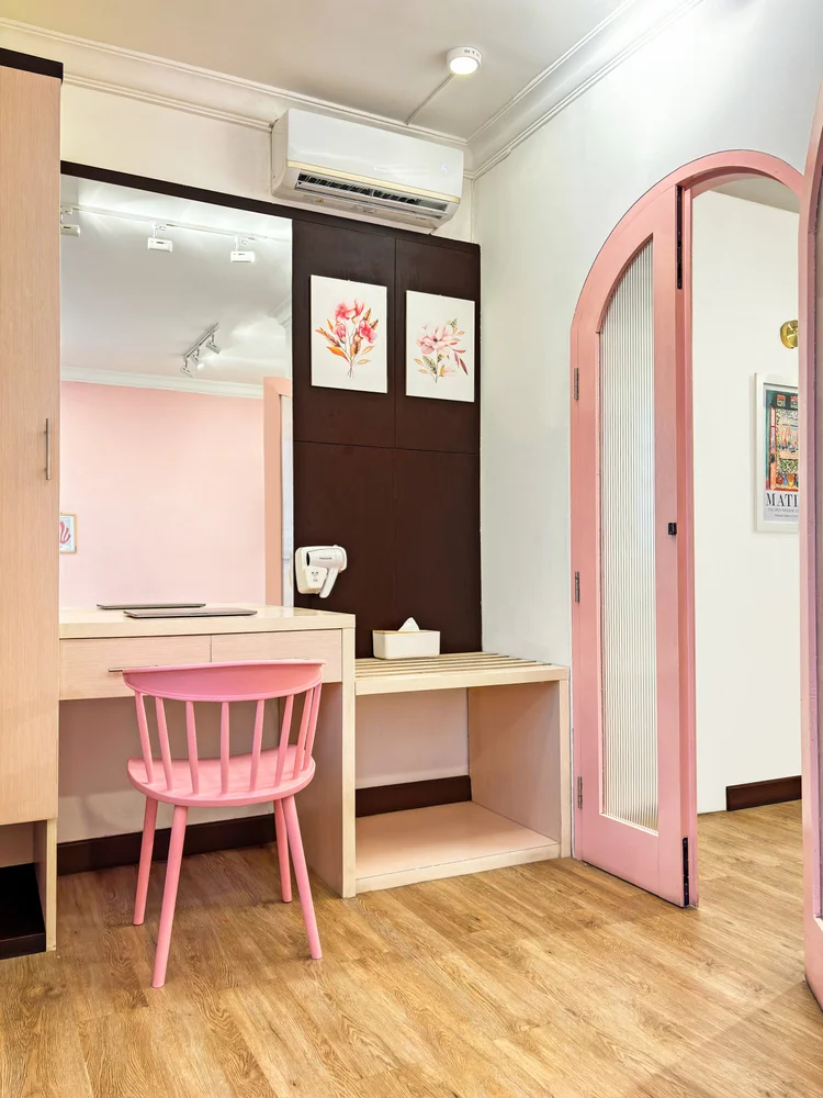 Milan: The bedroom with dressing table, a pink chair and its own AC.