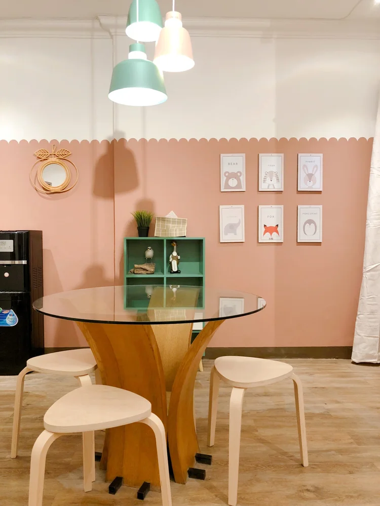 Madison: The dining table with its green shelf and prints, near the spacious open kitchen.