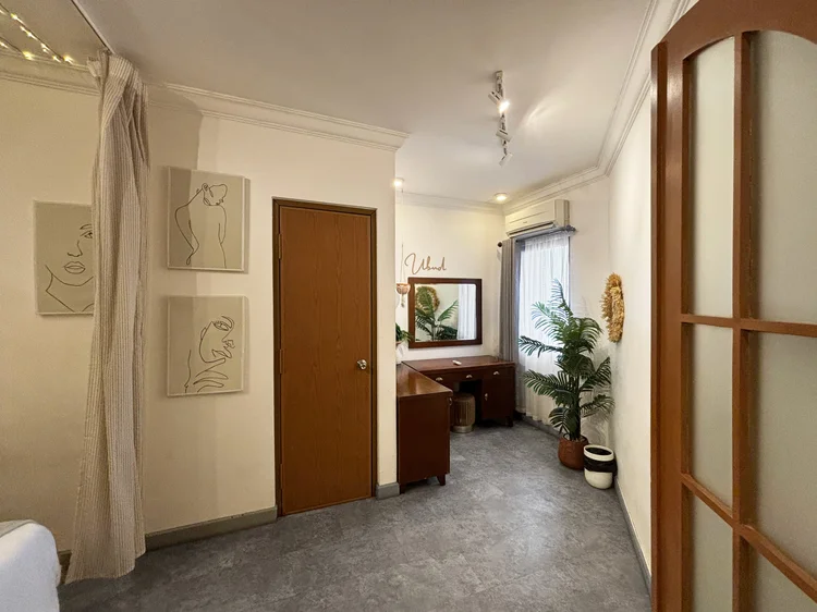 Ubud: The hallway to the bedrooms, with minimalist line art and plants along the way.