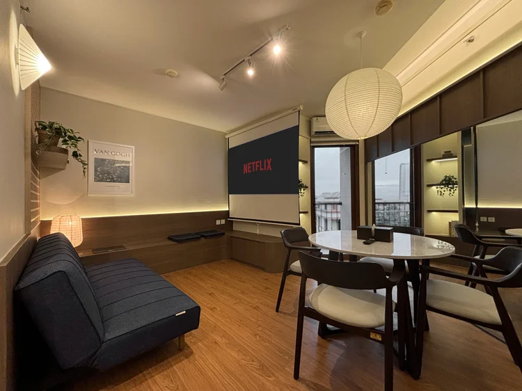 Aoyama: Cinema Experience Japandi: projector screen, sofa and dining table all in one room.