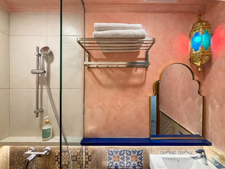 Marrakech: A pink arched mirror, a lantern, and clean towels for every guest.