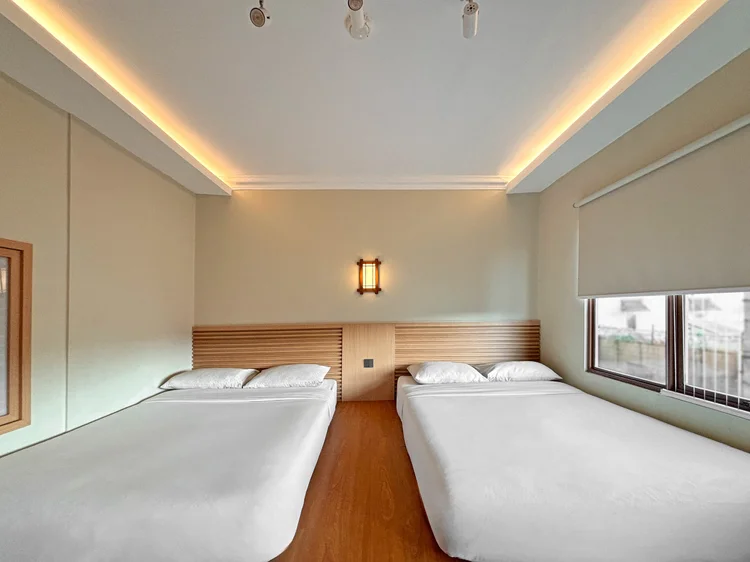 Nami: Two beds side by side, white sheets as in all our units.