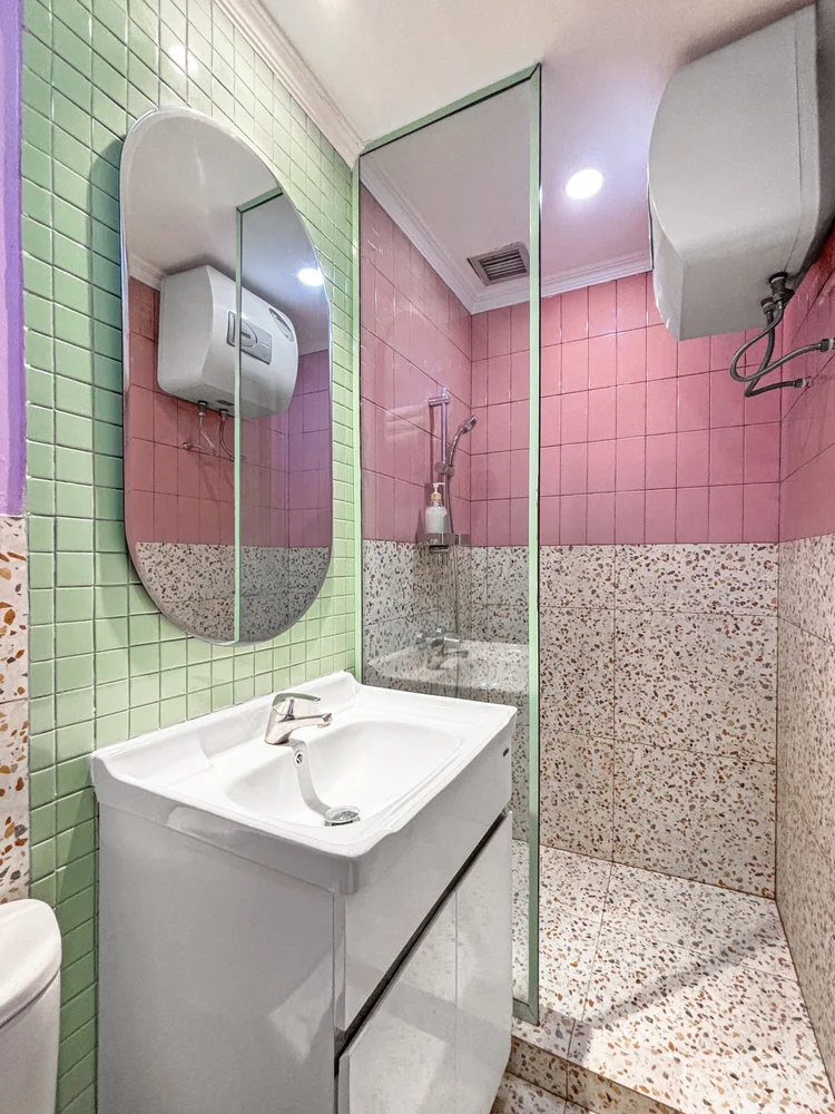 Milan: Bathroom in pink and green tiles; soap and shampoo the same in every unit.