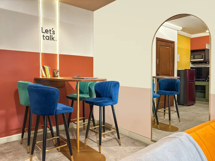 Geneva: The bar table by the open kitchen, under the Let's talk wall text.
